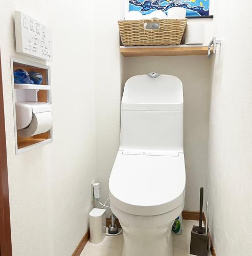 a bathroom with a white toilet in a room at Feliz Kumamoto in Kumamoto