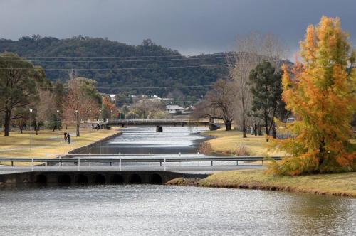 a bridge over a river in a park at Quart Pot House in Stanthorpe