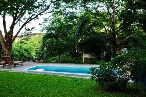 a swimming pool in the middle of a yard at Natural Villas Na Jomtien Pattaya Private Pool in Bang Sare