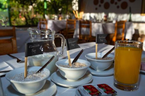 a table with bowls of rice and a pitcher of orange juice at Hotel El Abuelo in Carhuaz