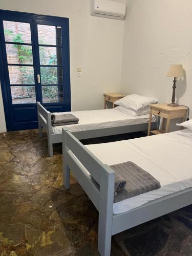 a room with three beds and a window at Villa Aliki Piskopiano in Hersonissos