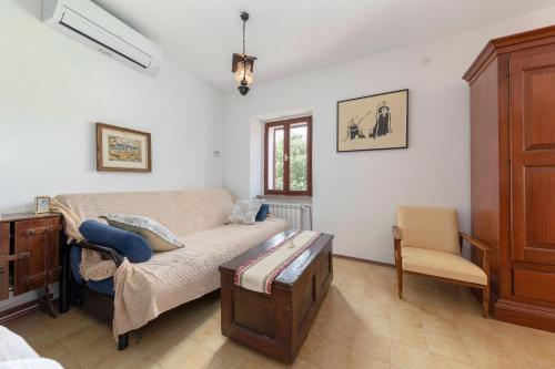 a bedroom with a bed and a desk and a chair at Under the rock house in Osp with jacuzzi in Osp