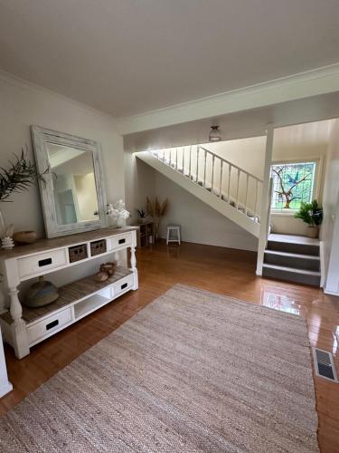 a large living room with a mirror and a staircase at StaySorrento in Sorrento