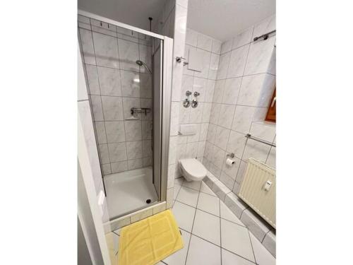a bathroom with a shower and a yellow stool at Holiday apartment Bergzeit, Allgäublick Steibis in Steibis