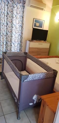 a bunk bed in a room with a tv at MARATHES STUDIOS in Agios Nikitas