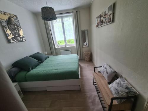 une chambre avec un lit vert et une fenêtre dans l'établissement appartement tout confort 48m2 - 1 chambre - boulogne sur mer, à Boulogne-sur-Mer