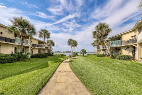 a path through a lawn with palm trees and condos at Sand Dollar E200 in Pensacola Beach