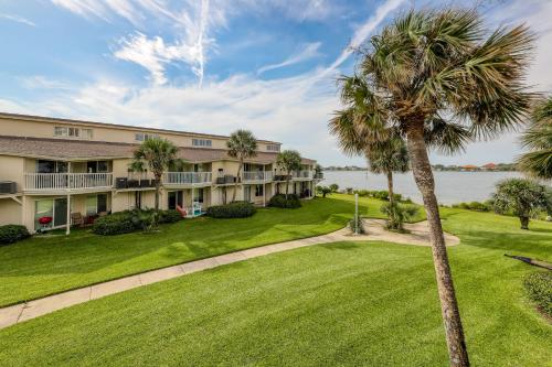 anterior view of a building with a palm tree at Sand Dollar E200 in Pensacola Beach