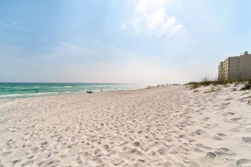 a sandy beach with the ocean in the background at Sand Dollar E200 in Pensacola Beach