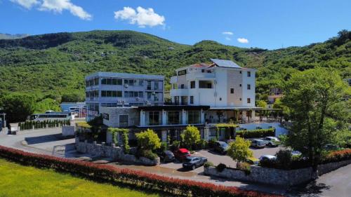 a large building in front of a mountain at Hotel Opera Jaz in Budva