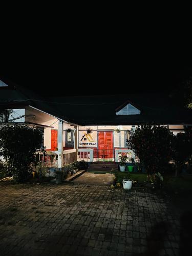 a building with a black canopy in a courtyard at Sunny Villa in Sivasagar