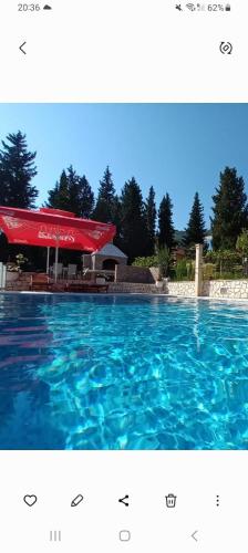 a swimming pool with blue water in front of a building at Villa Katarina in Tivat