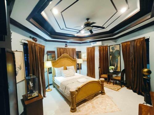 a bedroom with a bed and a ceiling at Negros Haven Seaside Resort in Camanjac