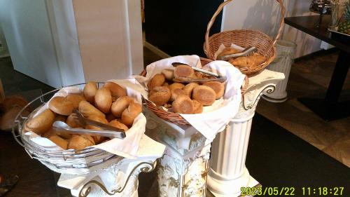 two baskets of bread sitting on a table at Hotel & Restaurant Sparta in Oldenburg