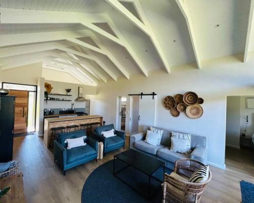 a living room with a blue couch and a fireplace at The Old Oke Riverhouse in Malgas