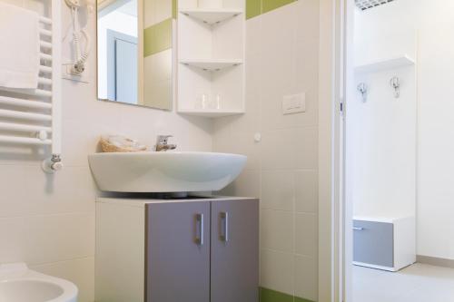 a white bathroom with a sink and a toilet at Hotel Campus Sanpaolo in Turin