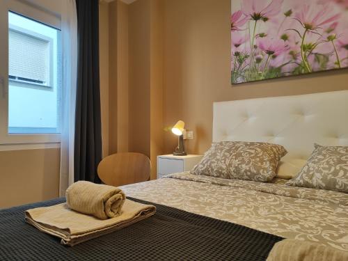 a bedroom with a bed with a towel on it at Apartamento Pedra Pateira in Ribeira