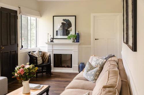 a living room with a couch and a fireplace at The Gatekeeper's Cottage in North Tamborine