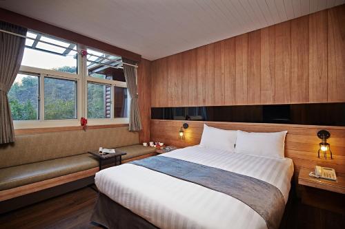 Un dormitorio con una cama grande y una ventana en Taichung Business Hotel - Immortals Hills en Heping