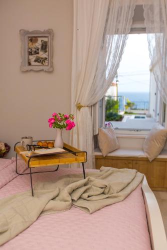 a bedroom with a bed with a table with flowers on it at Back in Time Luxury Dubrovnik 2 in Dubrovnik