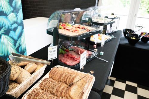 a buffet with bread and other food on a table at NeoHostel in Berlin