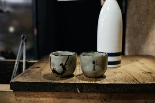 two cups sitting on top of a wooden table at InterContinental Cleveland by IHG in Cleveland