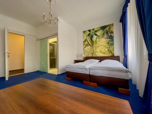 a bedroom with a bed and a painting on the wall at Hotel Růžek in Hranice