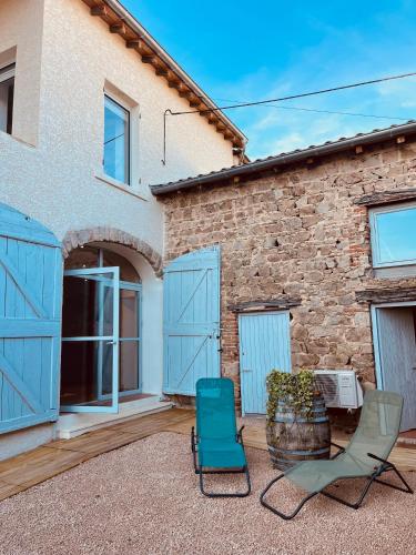 a couple of chairs sitting in front of a house at Bulles en Beaujolais Spa & Sauna in Fleurie