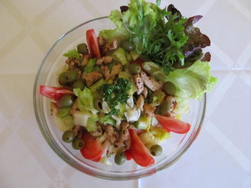 a salad with broccoli and other vegetables in a glass bowl at Hotel Růžek in Hranice
