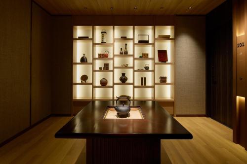 a room with a counter with a shelf with vases at Hotel Indigo Hakone Gora by IHG in Hakone