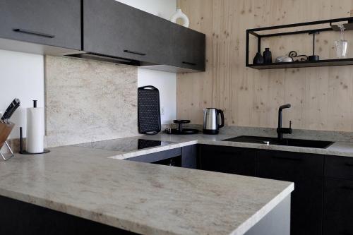 a kitchen with a sink and a counter top at Widderkopf in Oberstaufen