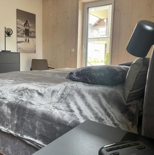 a bedroom with a bed with a pillow and a window at Widderkopf in Oberstaufen