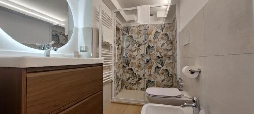 a bathroom with a sink and a toilet and a shower at La Mansarda sul Golfo in Portovenere