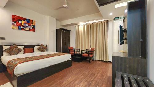 a hotel room with a bed and a table and chairs at Hotel The Prime Balaji Deluxe, City Centre, With Free Airport Pickup in New Delhi
