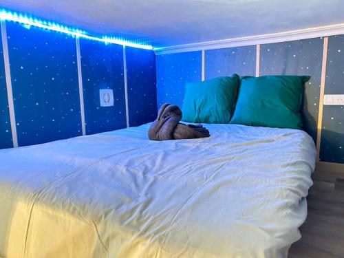 a stuffed animal is sitting on a bed at Charmant cocon, Lagny sur marne, parking, wifi, proche Disney RER in Lagny