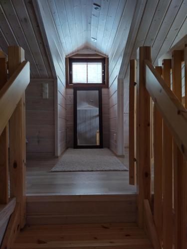 a wooden hallway with a door and a window at Ruka Star in Ruka