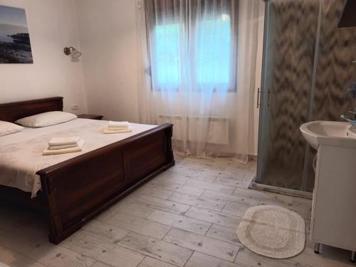 a bedroom with a bed and a shower and a sink at Villa Katarina in Tivat