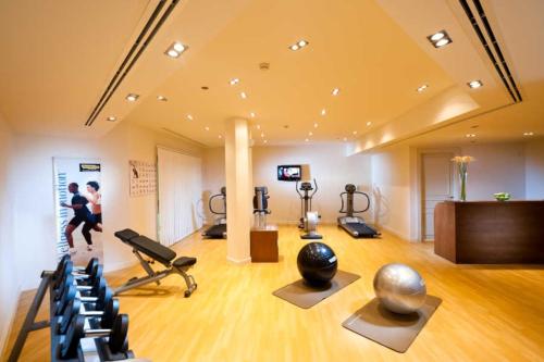a gym with treadmills and exercise equipment in a room at Wateera Jebel Sifah in As Sīfah