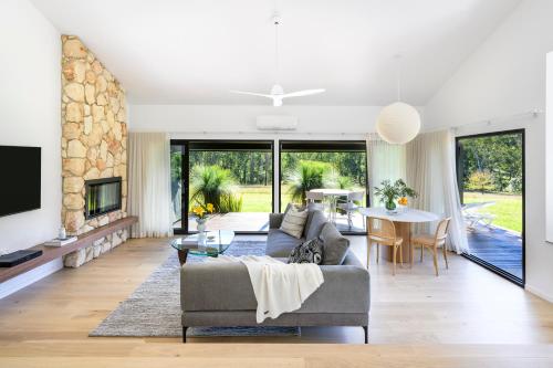 a living room with a couch and a table at Cedars Mount View (Adults Only) in Mount View