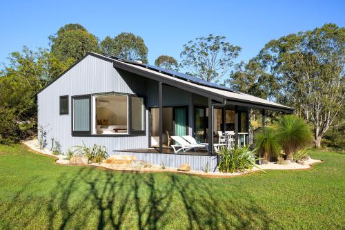 a white house with a black roof and a yard at Cedars Mount View (Adults Only) in Mount View