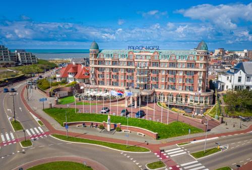 a large building in a city with a street at Van der Valk Palace Hotel Noordwijk in Noordwijk aan Zee