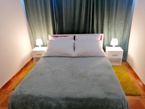 a bedroom with a bed with two night stands at TRI KRALJA - THREE KINGS Apartments in the center with private parking in Imotski