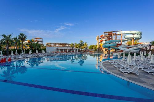 a large swimming pool with a water park at Bera Alanya Hotel - Halal All Inclusive in Konaklı
