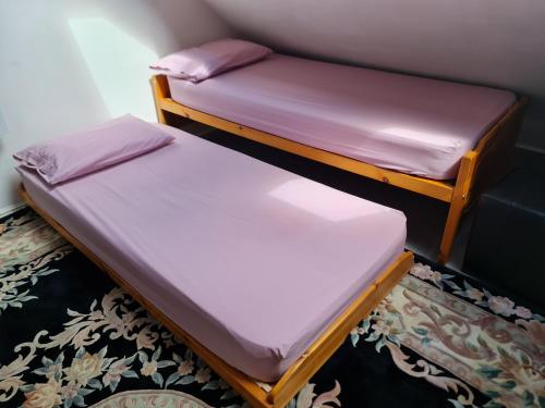two twin beds in a room with purple sheets at Large private room in Biddulph-Stoke On Trent in Biddulph