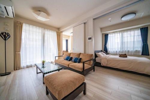 a hotel room with a bed and a couch at Morganite in Sapporo