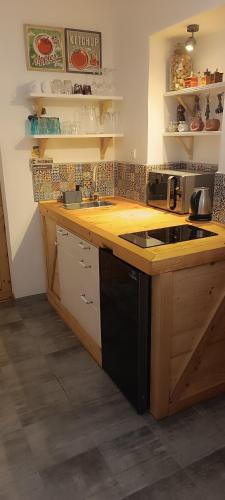 a kitchen with a wooden counter top with a sink at Apartmán Na pětce in Znojmo