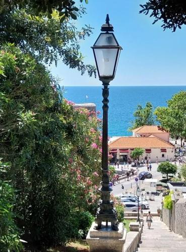 a street light on a sidewalk next to the ocean at Seaview Dubrovnik Old Town in Dubrovnik
