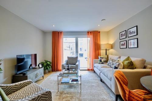 a living room with a couch and a tv at Lambert House in Harrogate