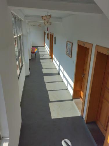 a hallway with a long aisle in a building at Lijiang Adventure Inn in Lijiang