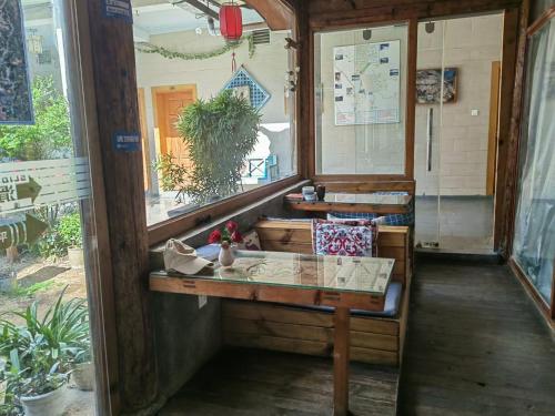 a room with a table and a mirror in a room at Lijiang Adventure Inn in Lijiang